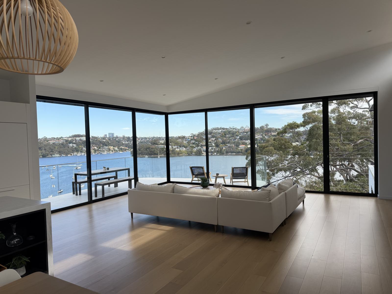 Living room with corner glass and harbour views, windows cleaned inside and out by Coastal Clear Windows